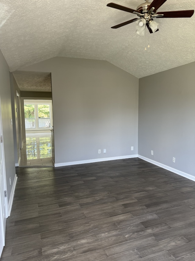 unfurnished room with a textured ceiling, lofted ceiling, dark hardwood / wood-style floors, and ceiling fan