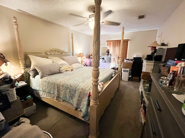 bedroom featuring ceiling fan, a textured ceiling, and dark colored carpet