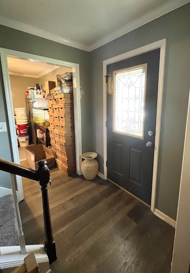 entrance foyer featuring ornamental molding, dark hardwood / wood-style flooring, and a textured ceiling