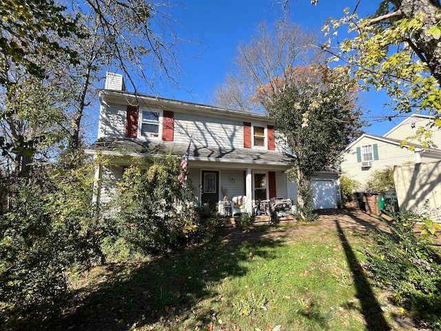 view of front of property featuring a front yard and covered porch