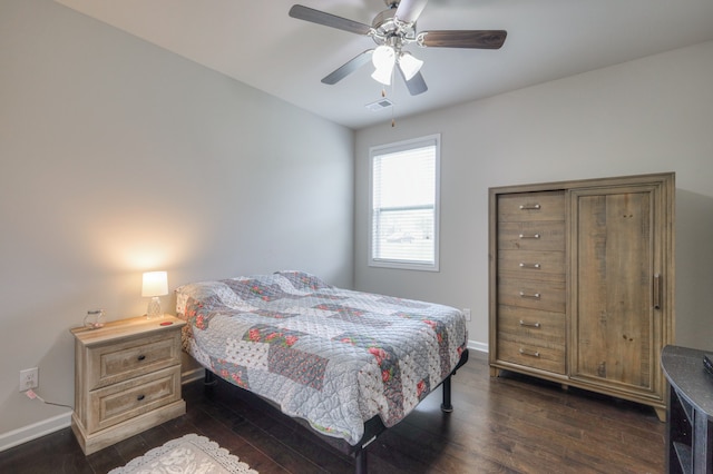 bedroom with ceiling fan and dark hardwood / wood-style floors