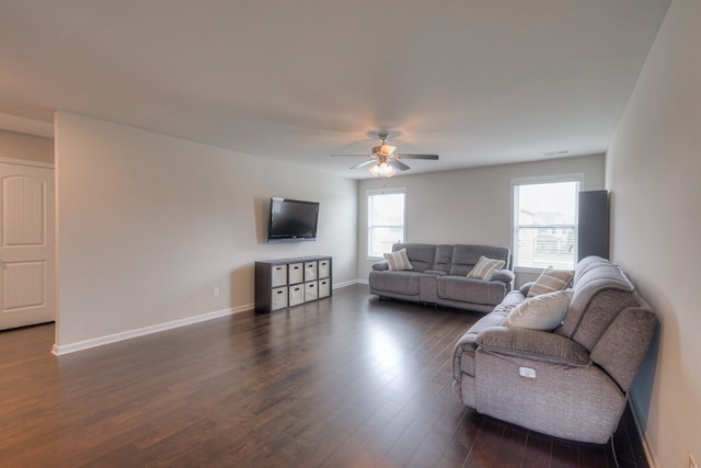 living room with dark wood-type flooring and ceiling fan