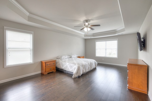 bedroom featuring ceiling fan, ornamental molding, a raised ceiling, and dark hardwood / wood-style flooring