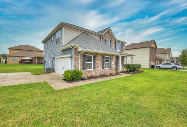 view of front of house with a front yard, central air condition unit, and a garage