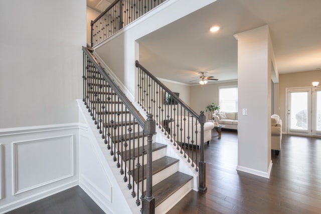 staircase with ceiling fan and hardwood / wood-style floors