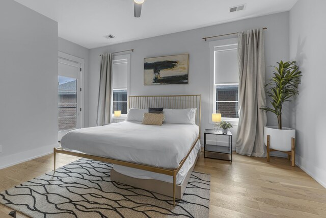 bedroom with light hardwood / wood-style flooring, ceiling fan, and access to outside