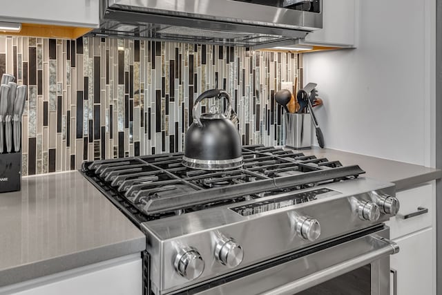 kitchen featuring white cabinetry and appliances with stainless steel finishes