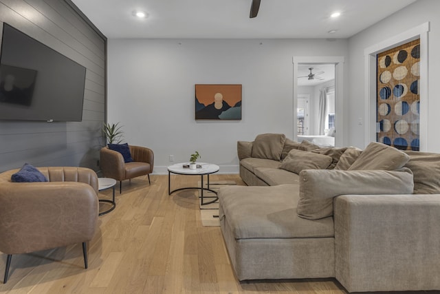 living room featuring ceiling fan and light hardwood / wood-style floors