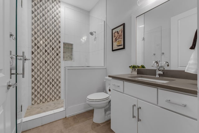 bathroom with vanity, tile patterned flooring, an enclosed shower, and toilet