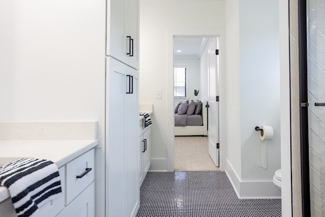 bathroom featuring vanity, tile patterned flooring, and toilet