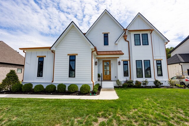 modern farmhouse style home with a front lawn