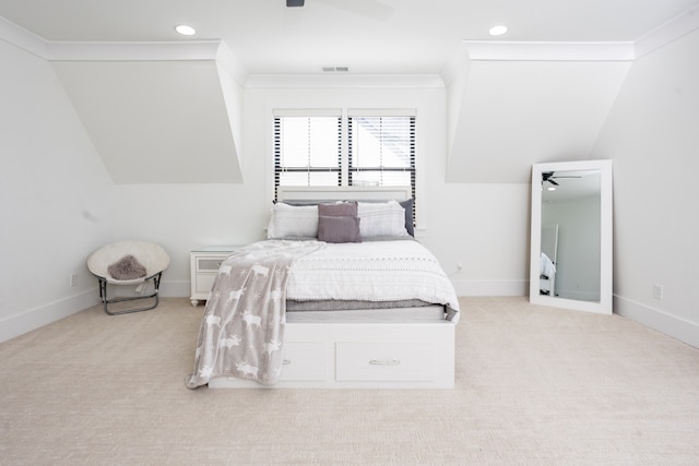 bedroom with ceiling fan, vaulted ceiling, light carpet, and ornamental molding