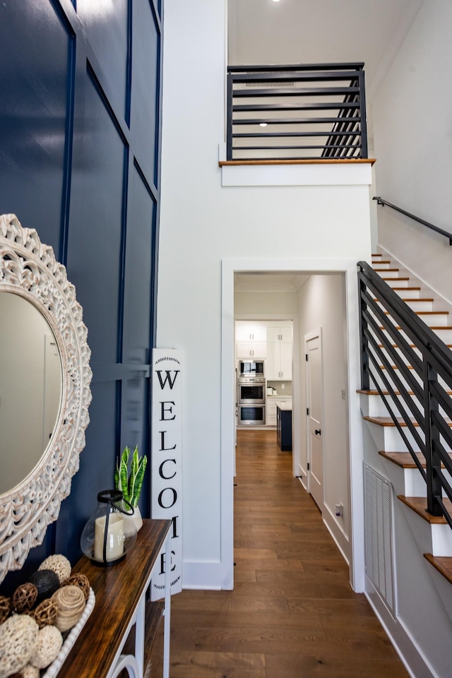 6821 Springwater St, Smyrna, TN 37167 - interior space with dark wood-style floors, crown molding, stairs, and a towering ceiling