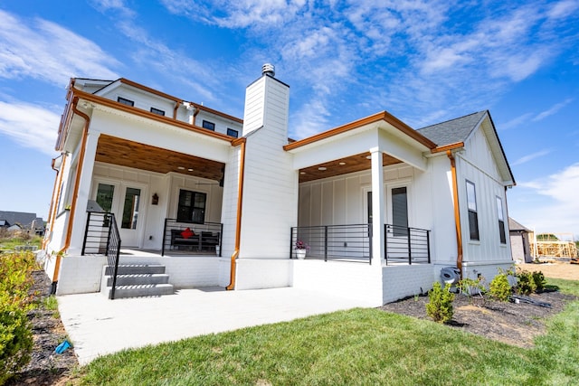 6821 Springwater St, Smyrna, TN 37167 - view of front of house featuring a chimney, a patio area, and board and batten siding