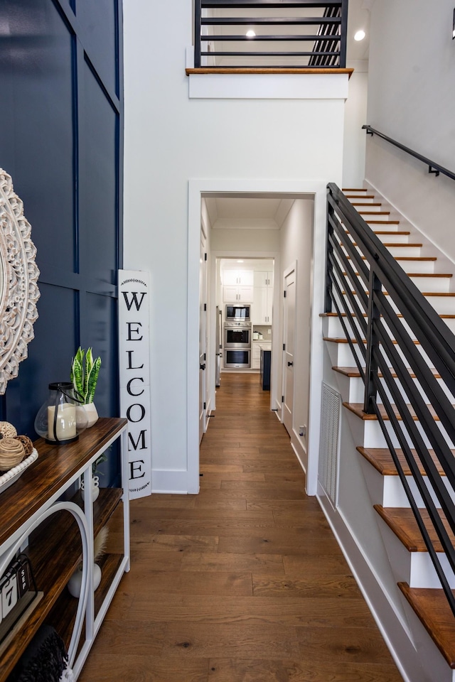 6821 Springwater St, Smyrna, TN 37167 - hallway with dark wood-style floors, baseboards, stairs, and crown molding