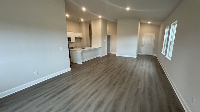 unfurnished living room with dark hardwood / wood-style floors