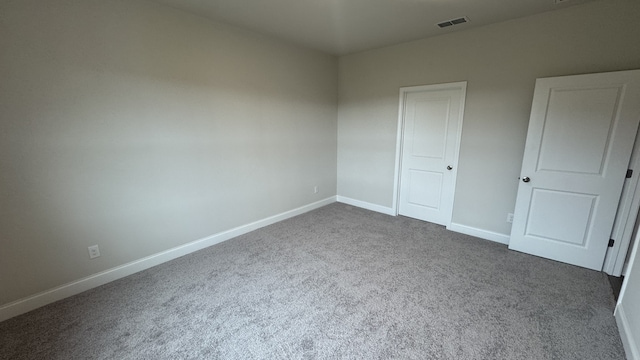 unfurnished bedroom with dark colored carpet