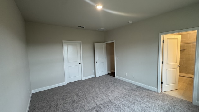 unfurnished bedroom with light colored carpet