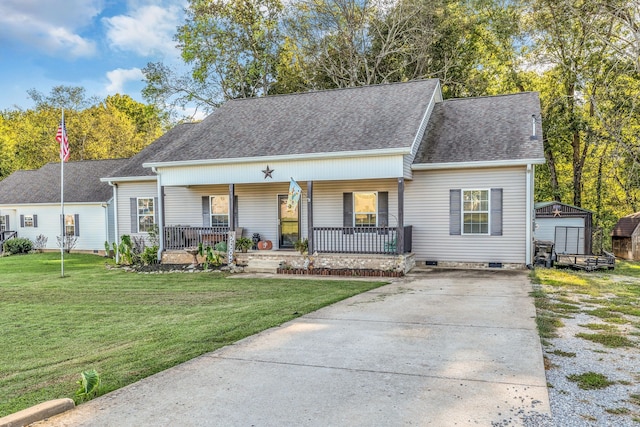 view of front facade with a front lawn, a storage shed, and a porch