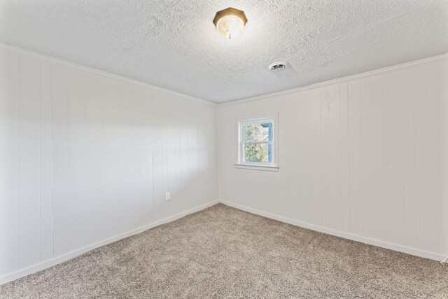 carpeted empty room with a textured ceiling