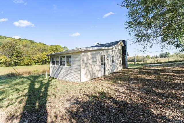 back of house with a lawn