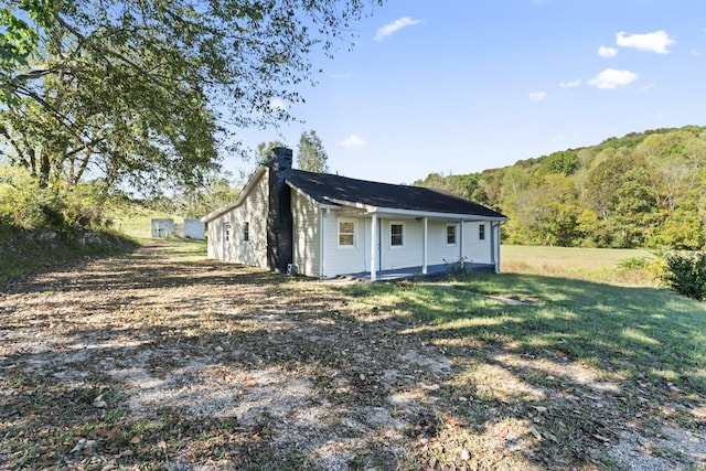 exterior space with a chimney and a yard