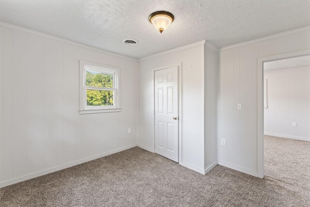 unfurnished bedroom with a textured ceiling, crown molding, and carpet