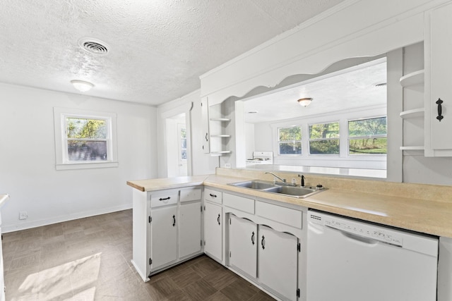 kitchen with open shelves, white dishwasher, a sink, light countertops, and a textured ceiling