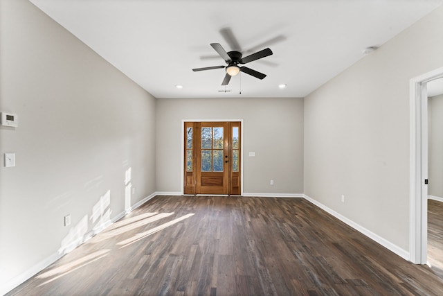 spare room featuring dark hardwood / wood-style flooring and ceiling fan