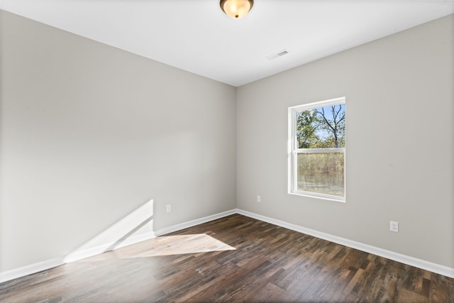 spare room featuring dark hardwood / wood-style flooring