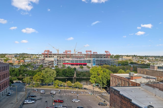 birds eye view of property featuring a water view and a view of city