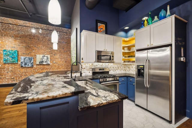 kitchen with white cabinets, a peninsula, a towering ceiling, stainless steel appliances, and open shelves