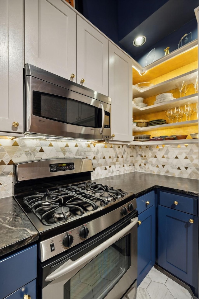 kitchen featuring blue cabinetry, white cabinetry, open shelves, stainless steel appliances, and decorative backsplash