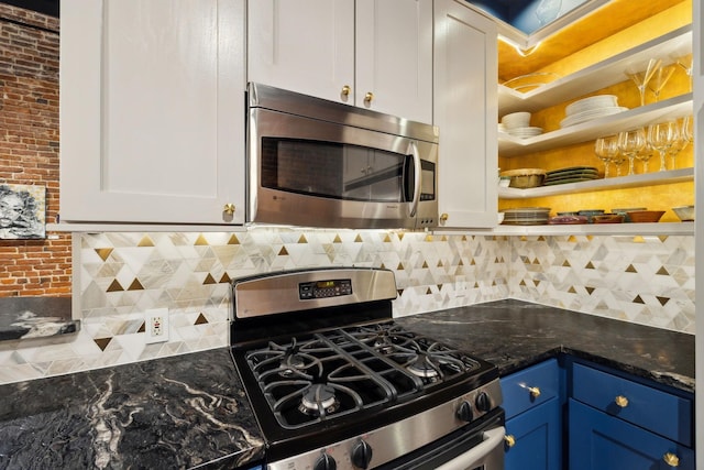 kitchen with blue cabinets, open shelves, backsplash, and appliances with stainless steel finishes