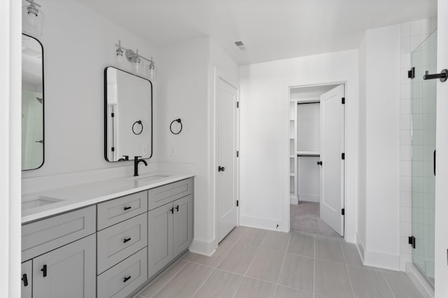 bathroom with vanity, tile patterned flooring, and walk in shower