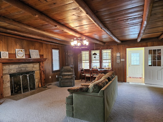 unfurnished living room with wood walls, carpet floors, beam ceiling, wood ceiling, and a fireplace