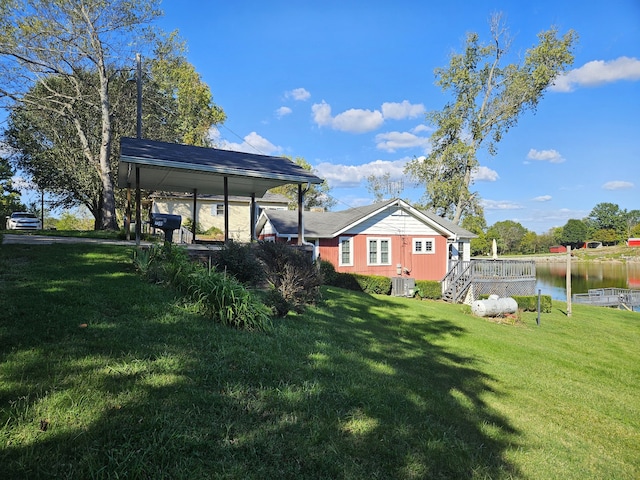 view of yard featuring central AC unit and a water view