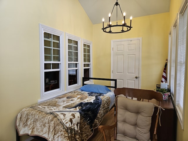 bedroom featuring a notable chandelier and vaulted ceiling