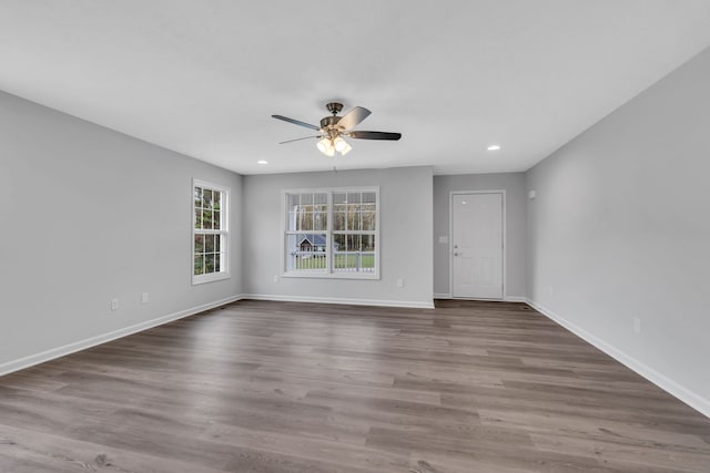 unfurnished room featuring dark wood-type flooring and ceiling fan