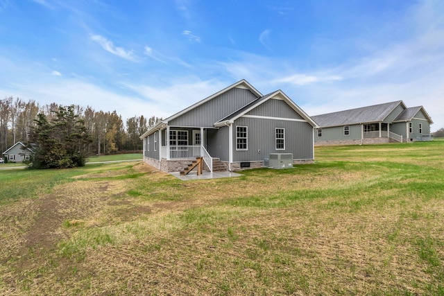 back of property featuring a patio, central AC, and a lawn