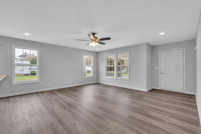 unfurnished living room featuring ceiling fan and light hardwood / wood-style flooring