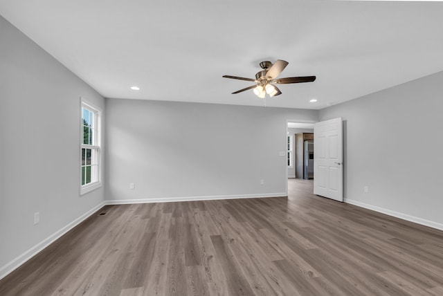 empty room featuring hardwood / wood-style flooring and ceiling fan