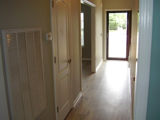 hall with light hardwood / wood-style floors