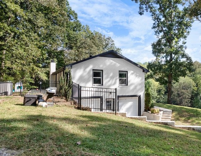 view of home's exterior with a garage and a yard