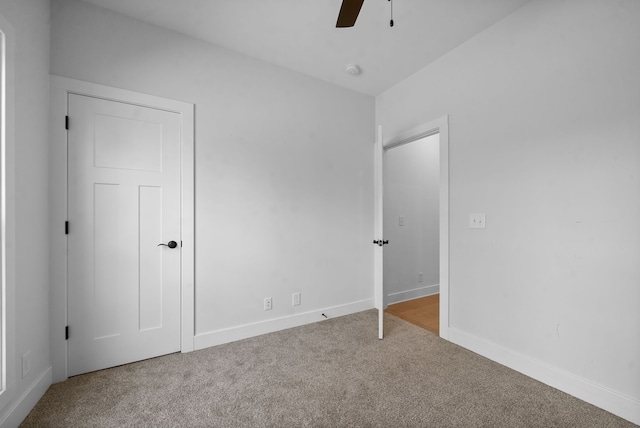 unfurnished bedroom featuring carpet floors and ceiling fan