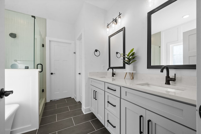 bathroom featuring vanity, tile patterned floors, and a shower with shower door