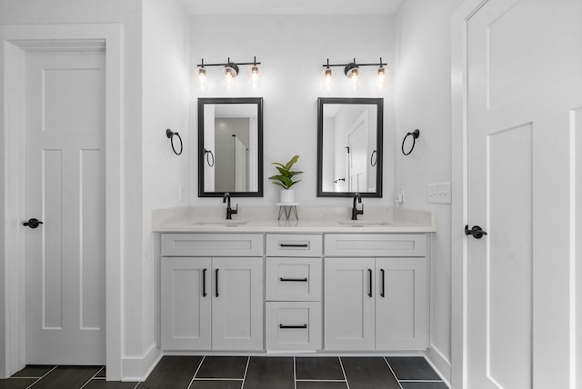 bathroom featuring tile patterned flooring and vanity