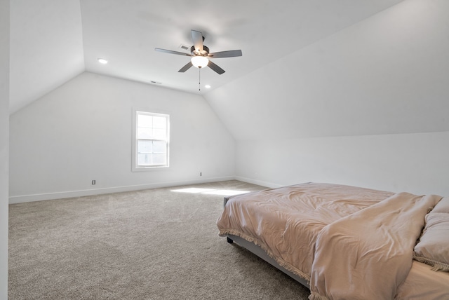 bedroom with light carpet, vaulted ceiling, and ceiling fan