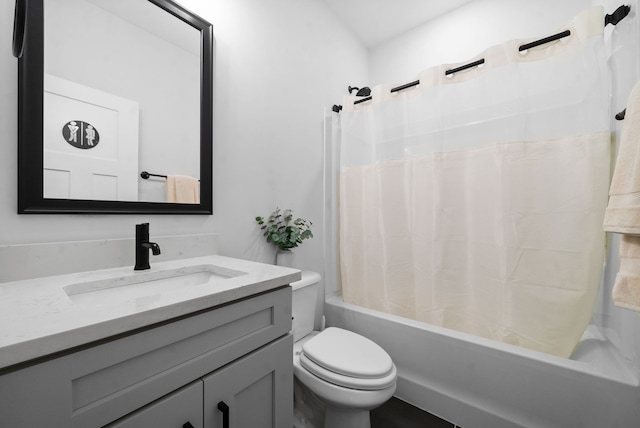 full bathroom with vanity, shower / bath combo with shower curtain, and toilet