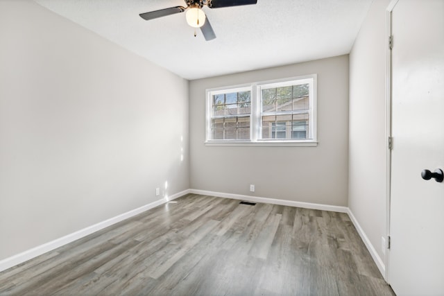 unfurnished room featuring light hardwood / wood-style floors, a textured ceiling, and ceiling fan